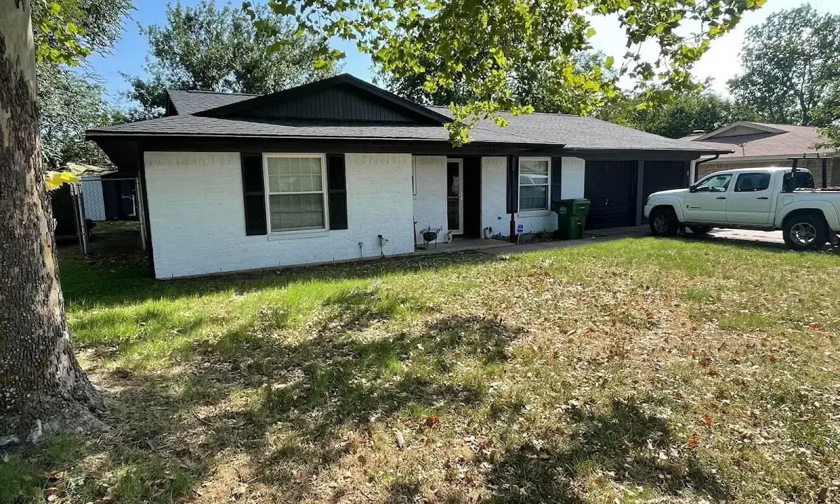 Professional roofing crew working on a residential roof in Littleton